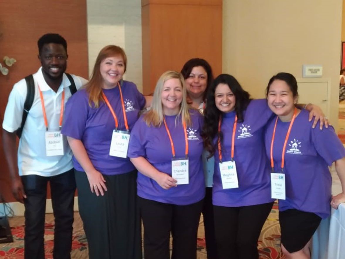 Volunteers in purple shirts at a brightspace daycare